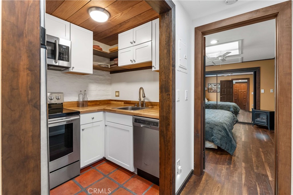 11550 Old Castle Road Valley Center, CA 92082 - Photo 39 of 74 a kitchen with stainless steel appliances granite countertop a stove and a sink
