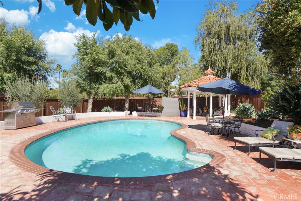 11550 Old Castle Road Valley Center, CA 92082 - Photo 44 of 74 a view of a swimming pool with lawn chairs under an umbrella