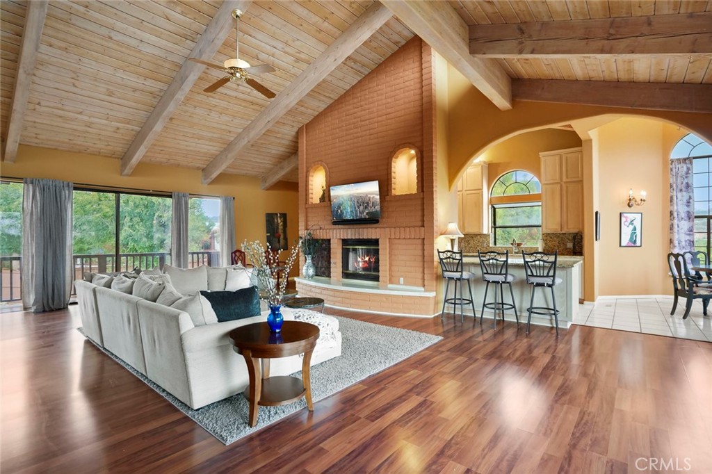 11550 Old Castle Road Valley Center, CA 92082 - Photo 48 of 74 a living room with fireplace furniture and a wooden floor
