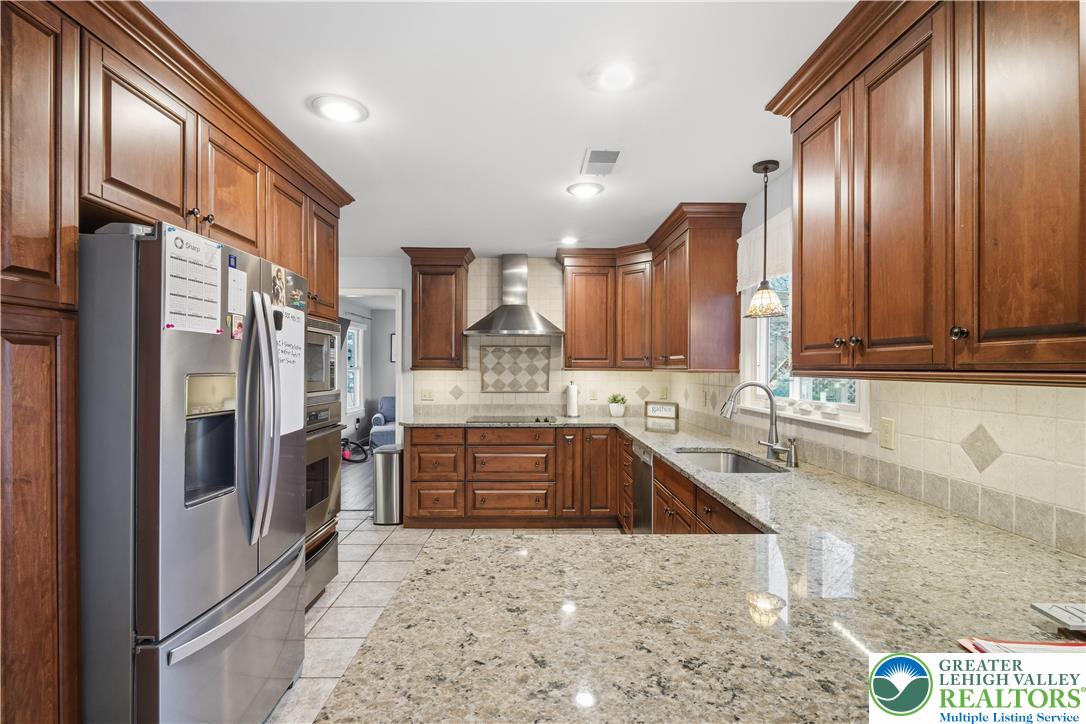 2160 Kecks Road Fogelsville, PA 18051 - Photo 28 of 58 a large kitchen with stainless steel appliances granite countertop a refrigerator and a sink