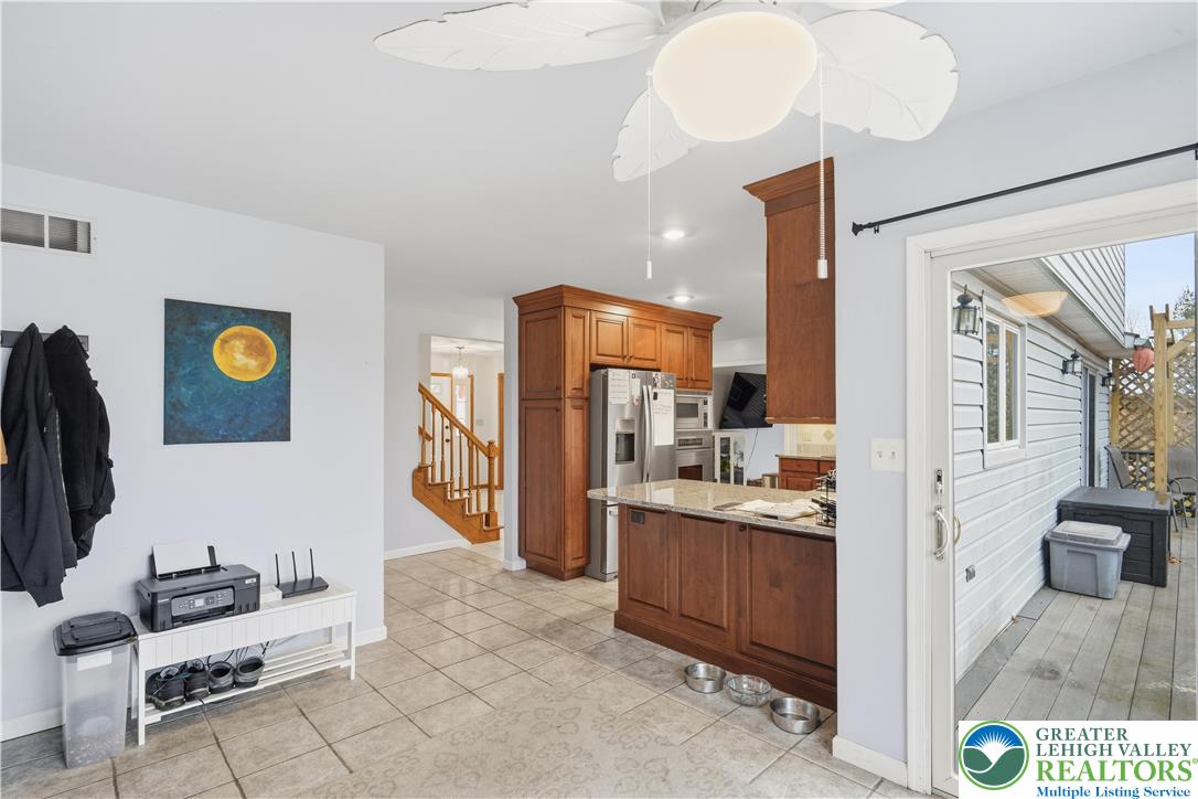 2160 Kecks Road Fogelsville, PA 18051 - Photo 30 of 58 a view of a kitchen with kitchen island granite countertop wooden cabinets and stainless steel appliances