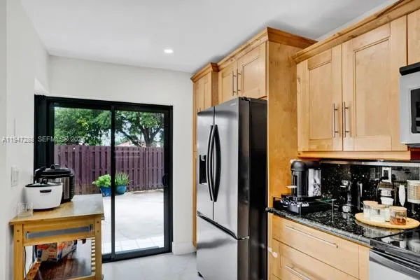 a kitchen with a refrigerator and a sink