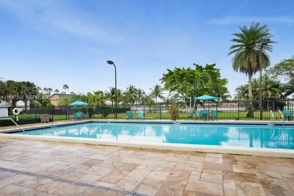a view of a swimming pool and a yard