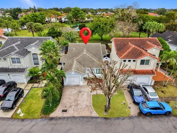an aerial view of a house with garden space and pool