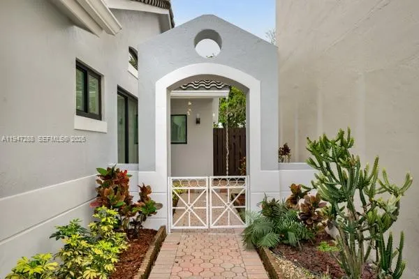 a view of a house with potted plants