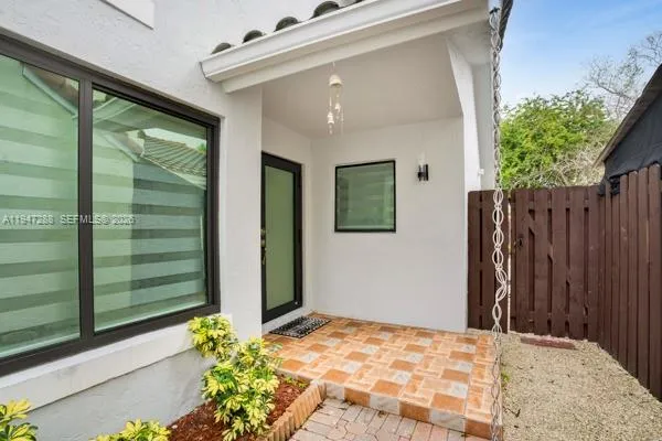 a view of backyard with deck and a garden