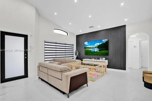 a living room with furniture and a flat screen tv