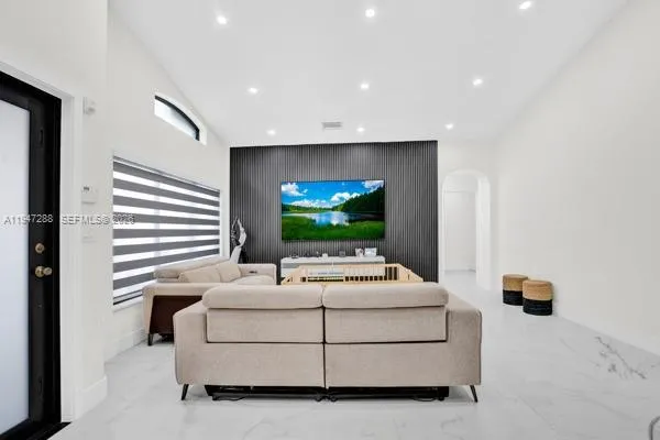a living room with furniture and a flat screen tv