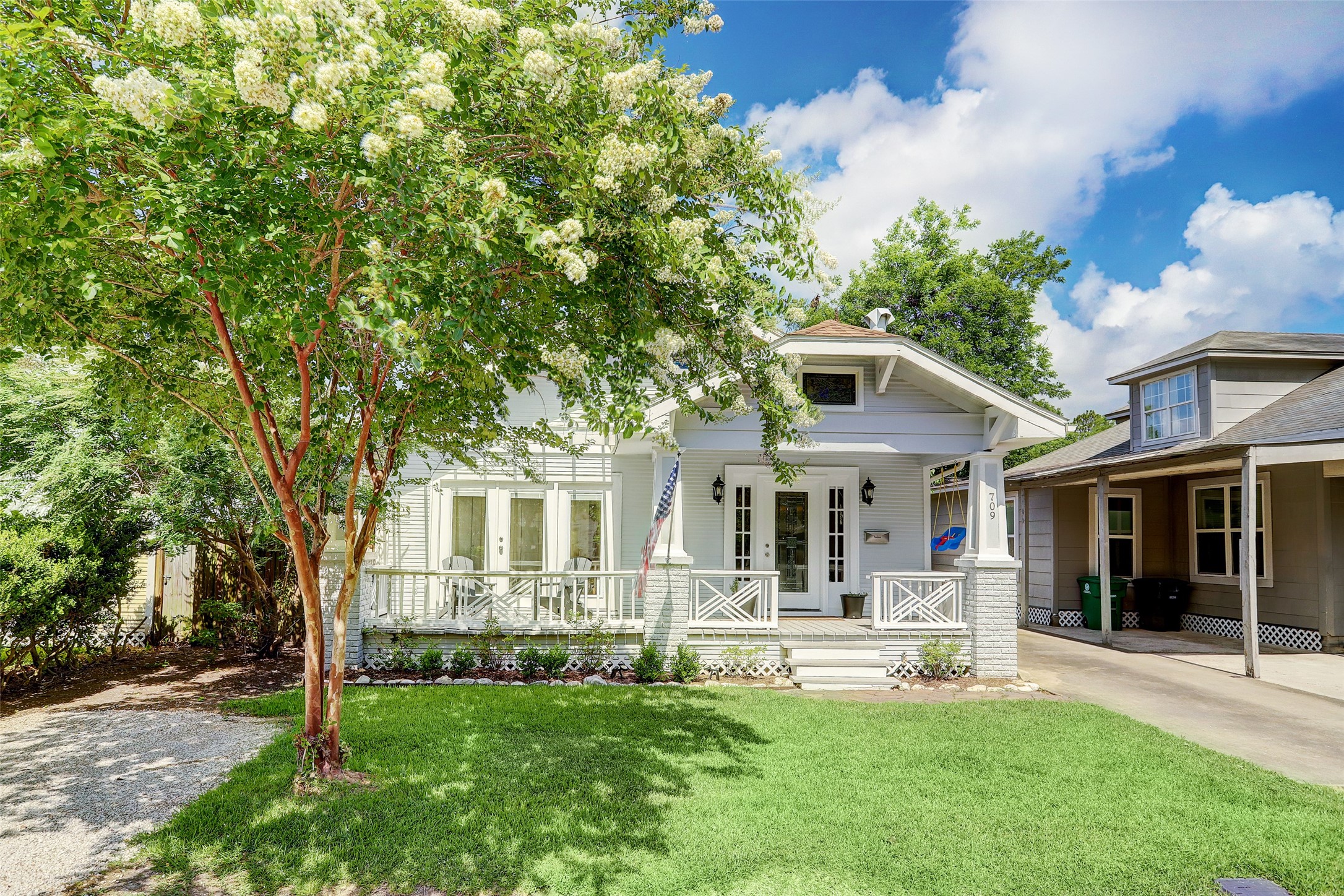 Neat curb appeal with a spacious porch, shaded front yard, and driveway parking. (this first picture was taken in the spring)