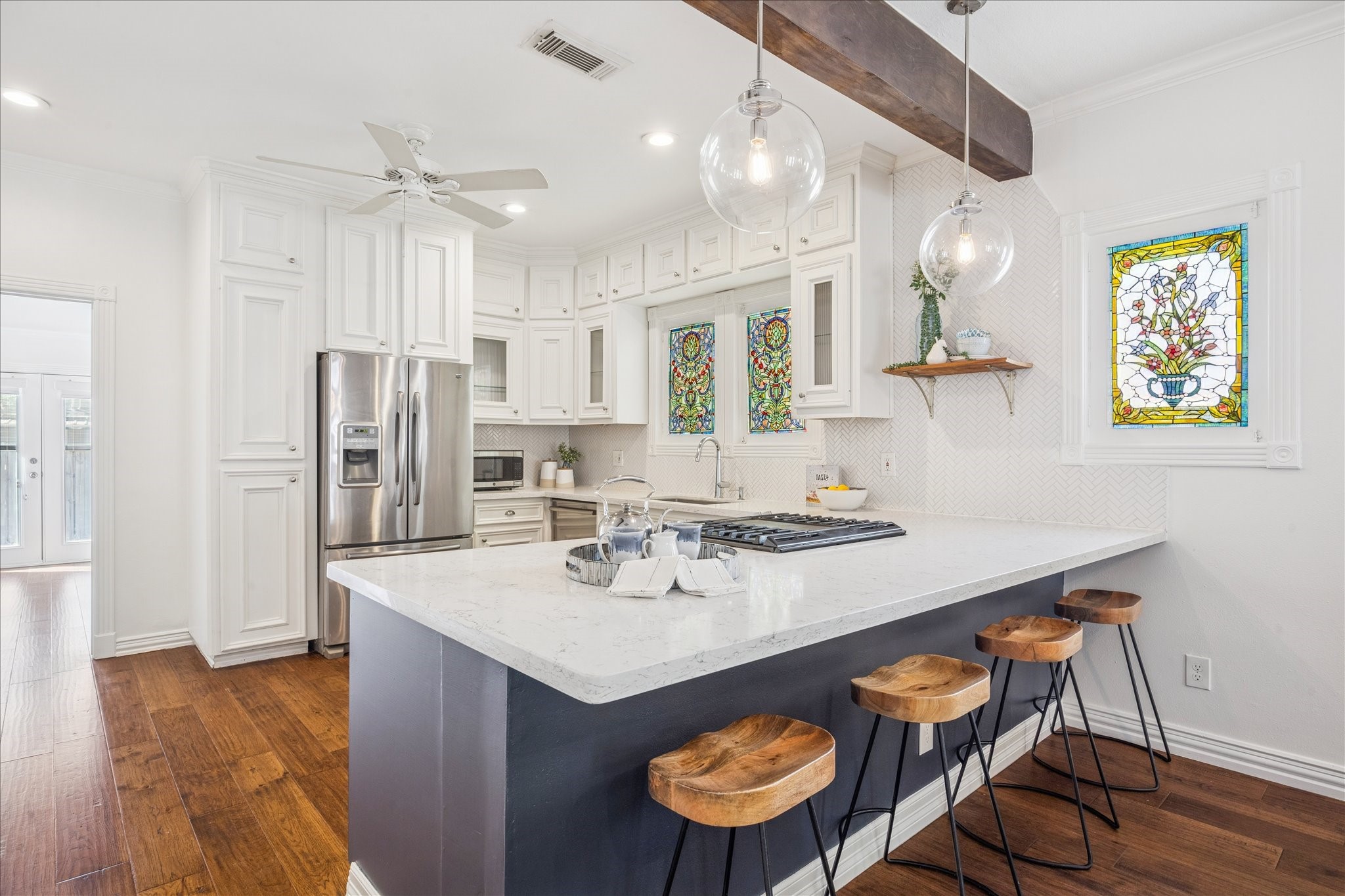 709 Walton Street Houston, TX 77009 - Photo 11 of 31 Open kitchen with a large island, quartz countertops, stainless steel appliances, and bar seating.