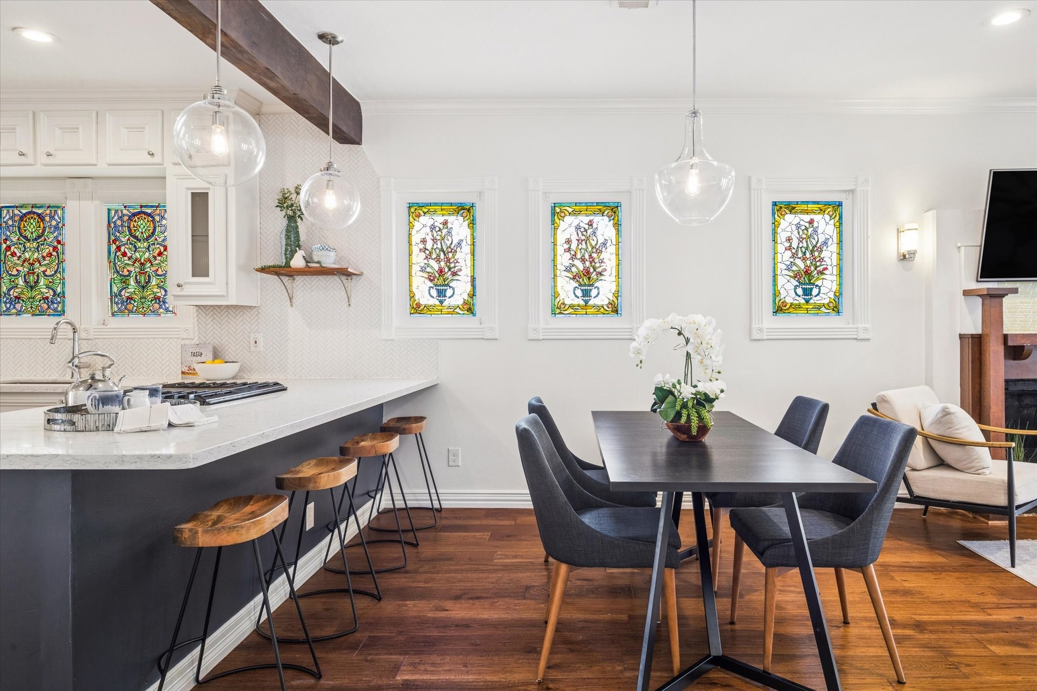 709 Walton Street Houston, TX 77009 - Photo 12 of 31 Functional dining space featuring stained-glass windows, bar seating, and direct access to the kitchen.