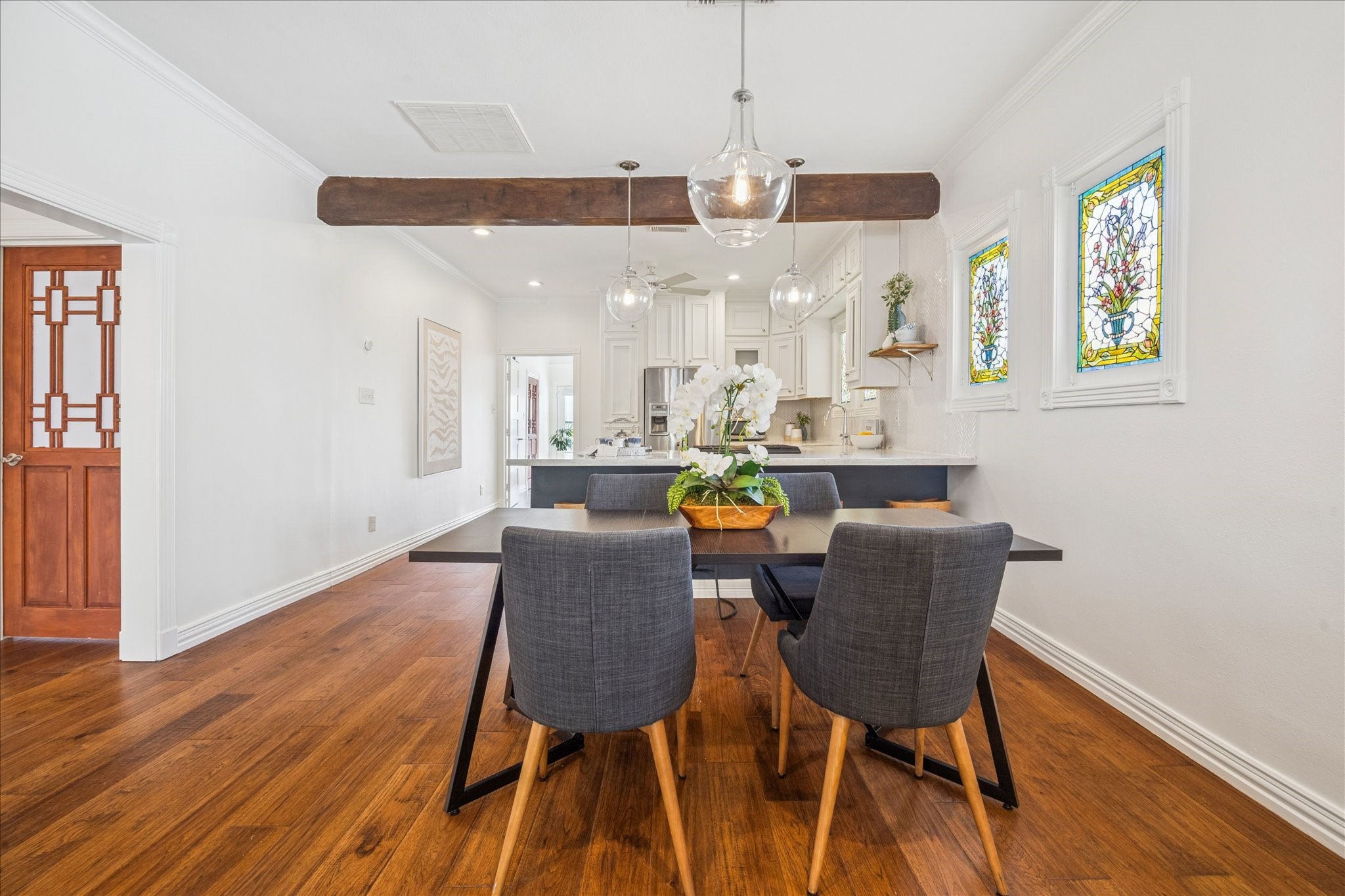 709 Walton Street Houston, TX 77009 - Photo 14 of 31 Dining area with hardwood floors, pendant lighting, and open access to the kitchen.