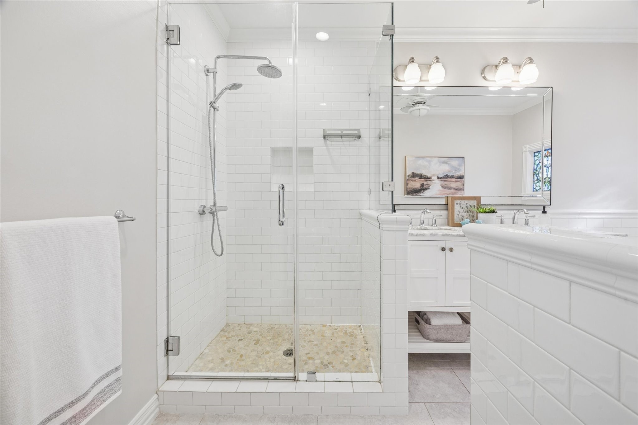 709 Walton Street Houston, TX 77009 - Photo 19 of 31 Primary bathroom with a walk-in glass shower, white tile finishes, and updated vanity.