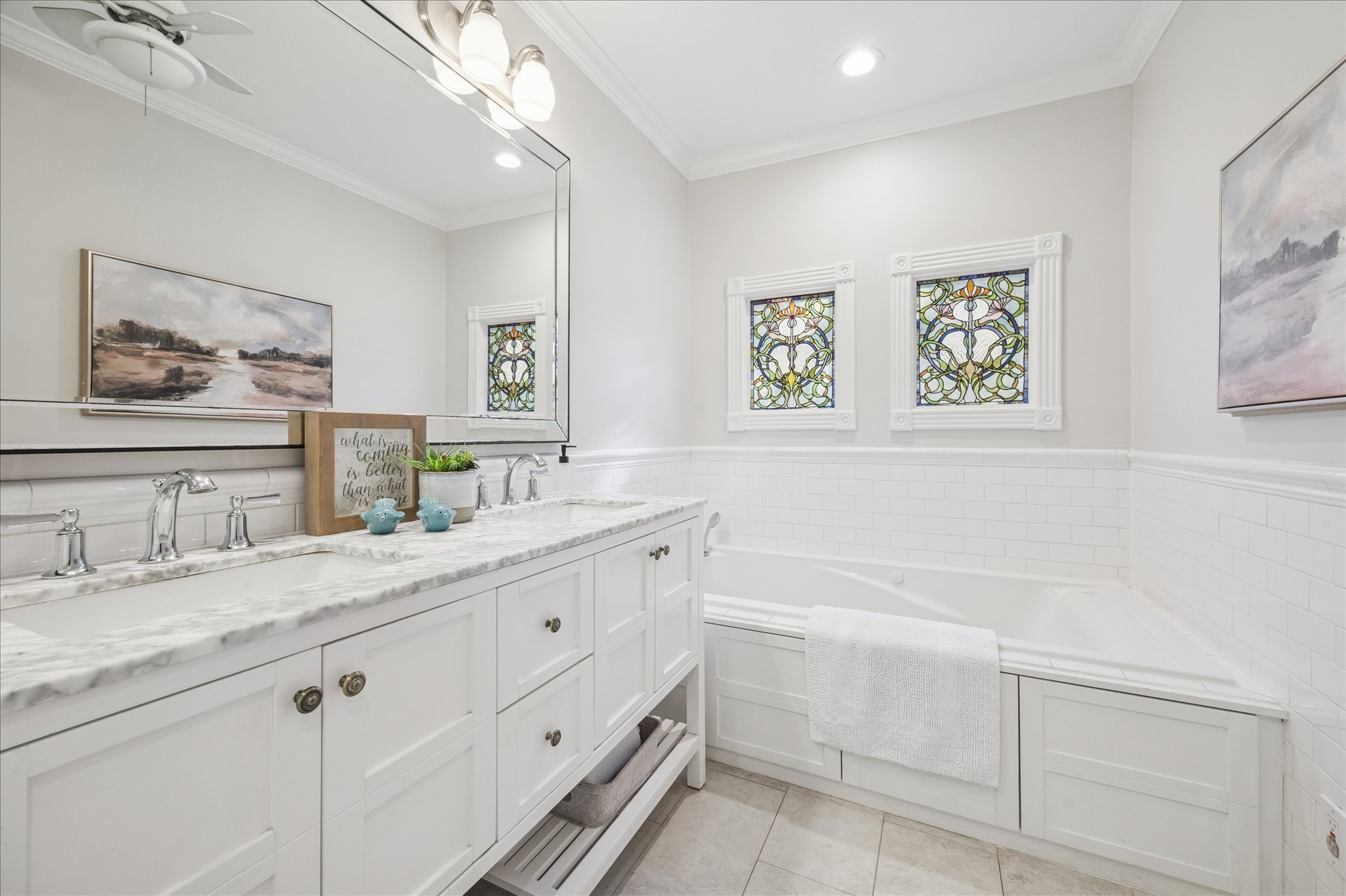 709 Walton Street Houston, TX 77009 - Photo 20 of 31 Spacious bath featuring a large vanity, tub surround, and updated lighting.