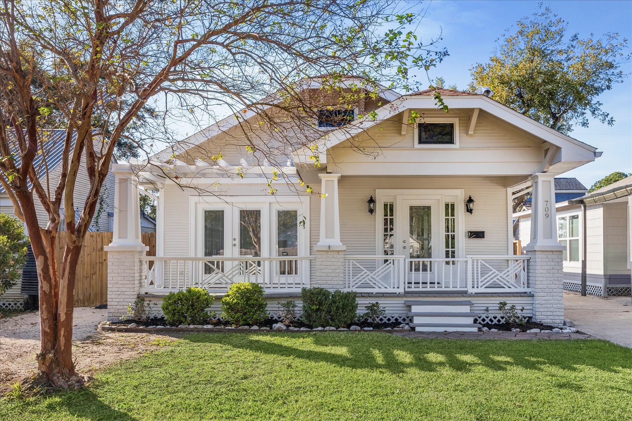 709 Walton Street Houston, TX 77009 - Photo 2 of 31 Well-maintained façade featuring a large front porch, fresh paint, and a tidy lawn.