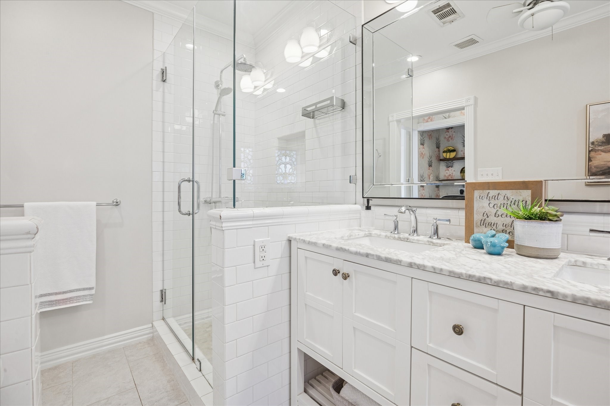 709 Walton Street Houston, TX 77009 - Photo 21 of 31 Clean bathroom layout with glass shower enclosure, tiled surfaces, and functional storage.
