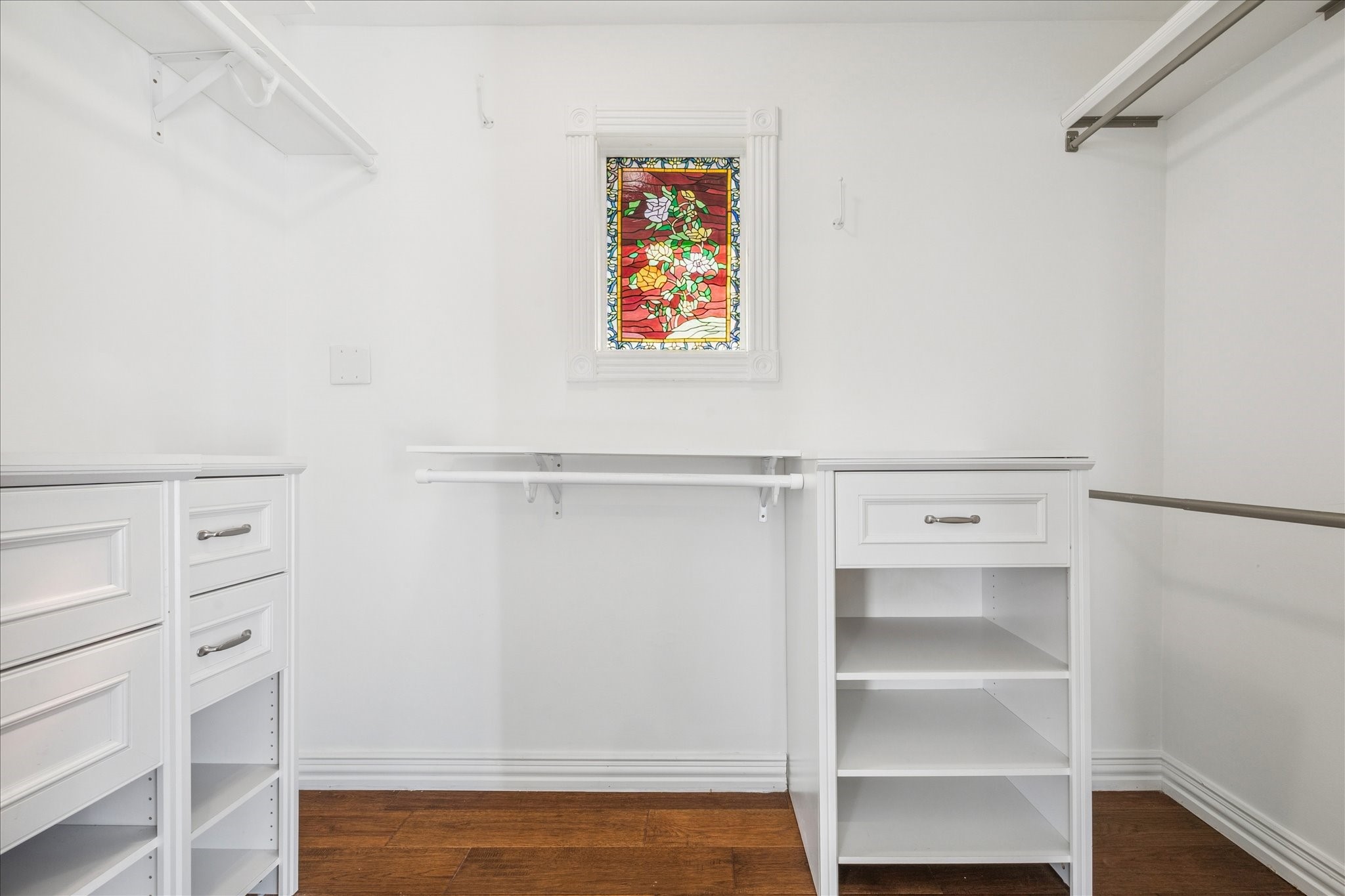 709 Walton Street Houston, TX 77009 - Photo 22 of 31 Walk-in closet featuring custom storage, wood flooring, and natural light.