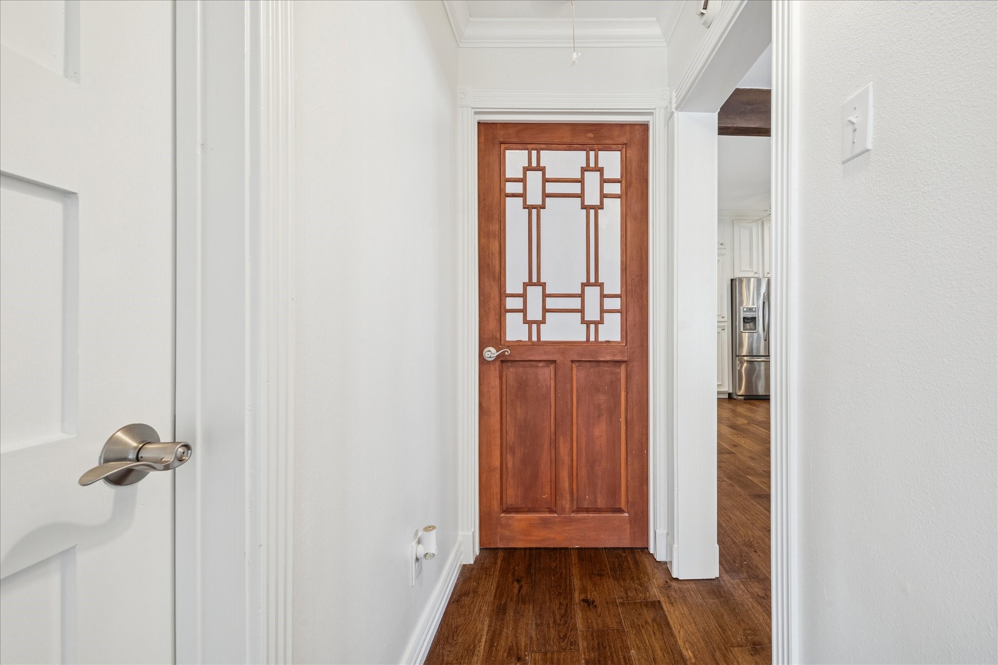 709 Walton Street Houston, TX 77009 - Photo 24 of 31 Hallway featuring clean finishes, wood flooring, and decorative interior door.