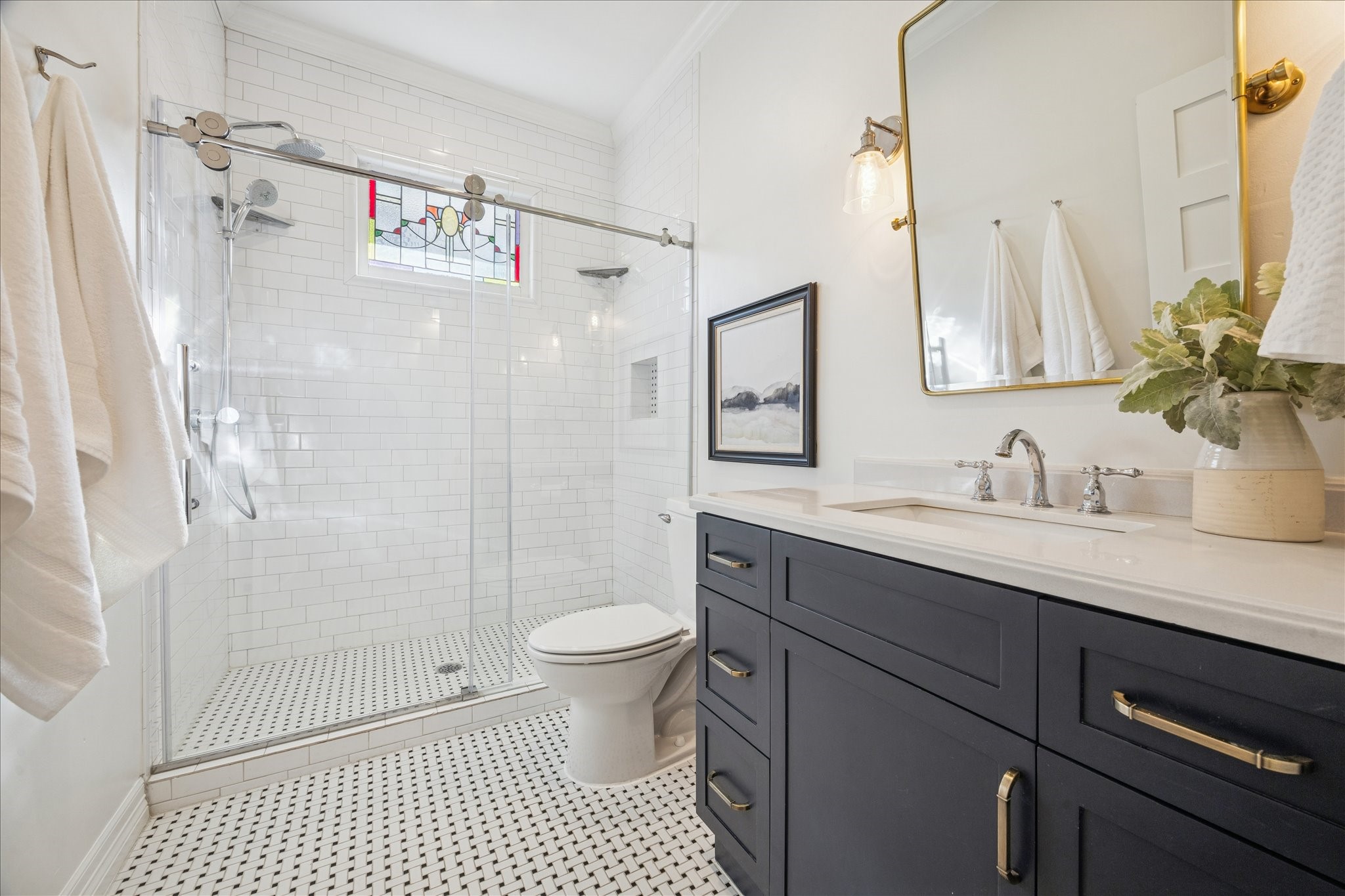709 Walton Street Houston, TX 77009 - Photo 26 of 31 Functional bathroom with tiled shower, solid-surface counters, and ample storage.
