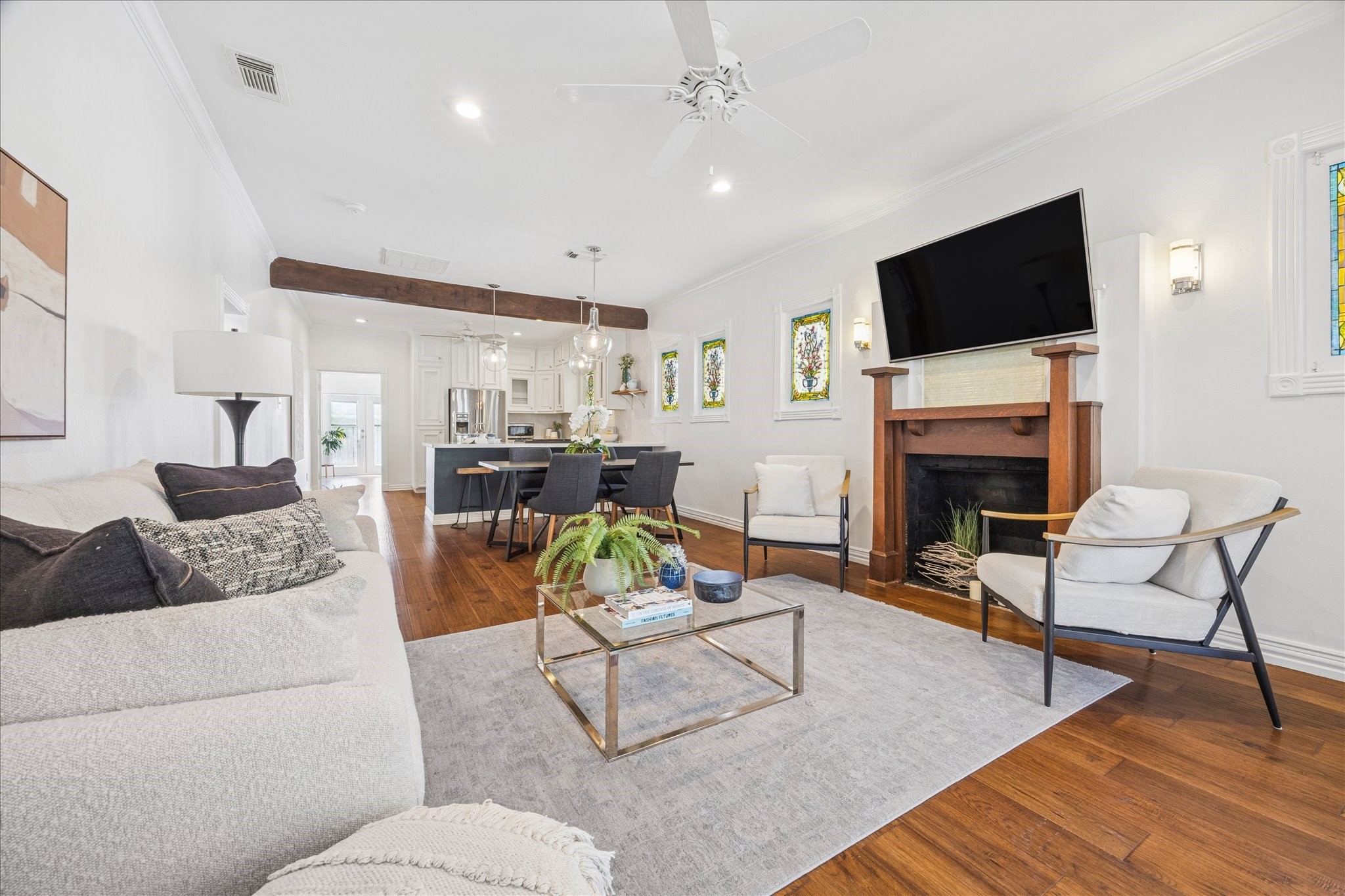 709 Walton Street Houston, TX 77009 - Photo 4 of 31 Open living area with hardwood floors, a central fireplace, and clear flow into the kitchen and dining space.