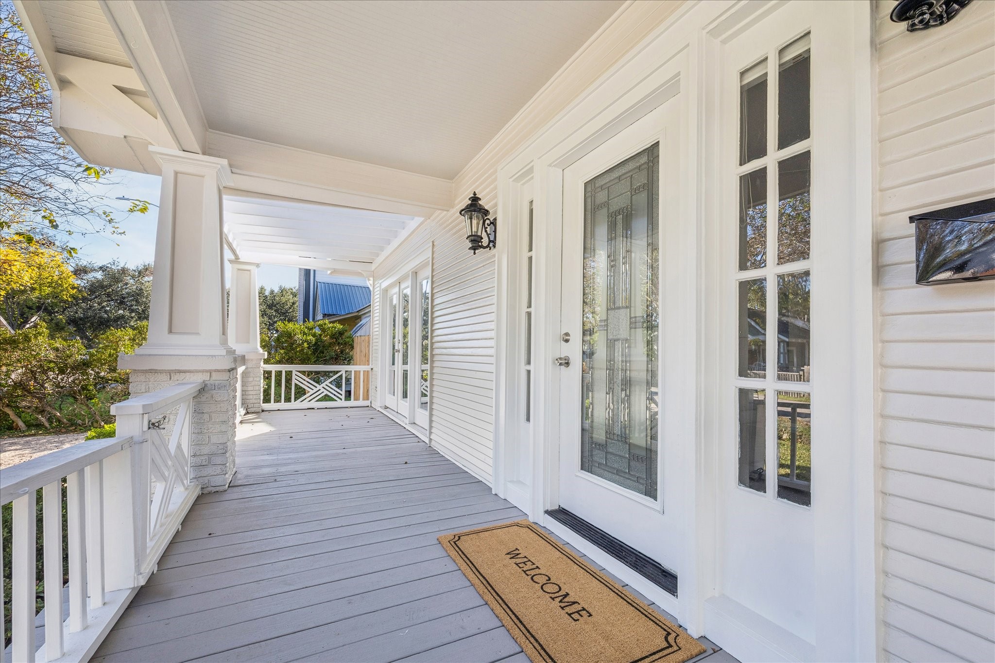 709 Walton Street Houston, TX 77009 - Photo 8 of 31 Spacious front porch featuring fresh paint, detailed railing, and a glass-panel entry door.