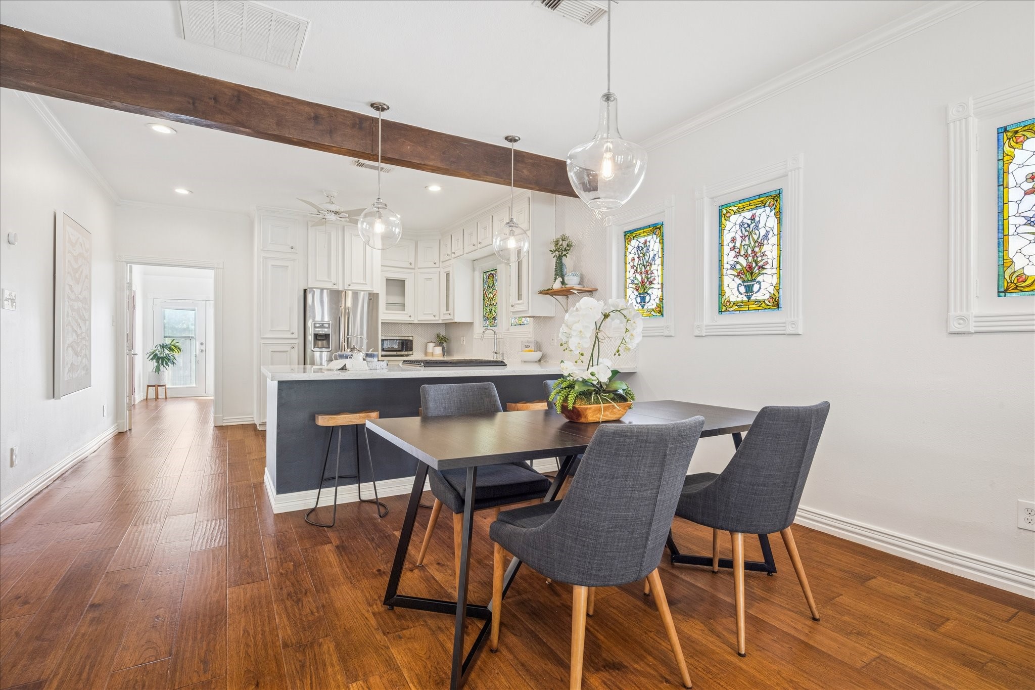 709 Walton Street Houston, TX 77009 - Photo 10 of 31 Dining area with hardwood floors, pendant lighting, and open access to the kitchen.
