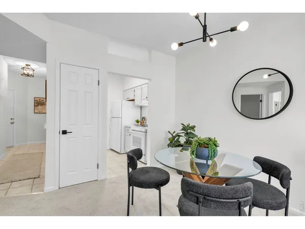 a living room with furniture and a mirror