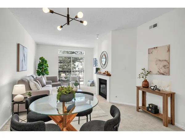 a living room with furniture a flat screen tv and a table