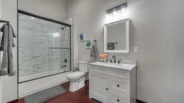 a view of a hallway with closet and wooden floor