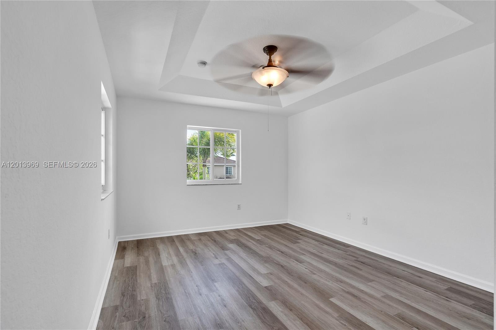 14044 Southwest 273rd Lane, Unit 14044 Homestead, FL 33032 - Photo 18 of 44 an empty room with a window and a ceiling fan