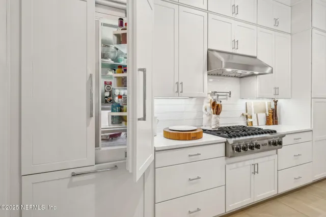 a bedroom with a bed and painting on the wall