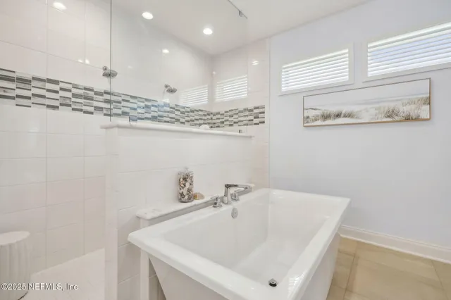 a living room with furniture and large windows