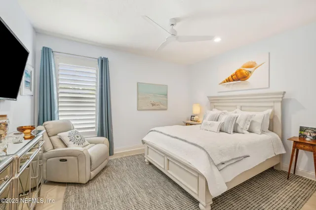 a view of a patio with table and chairs potted plants and a large tree