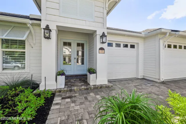 a living room with furniture and a painting on the wall