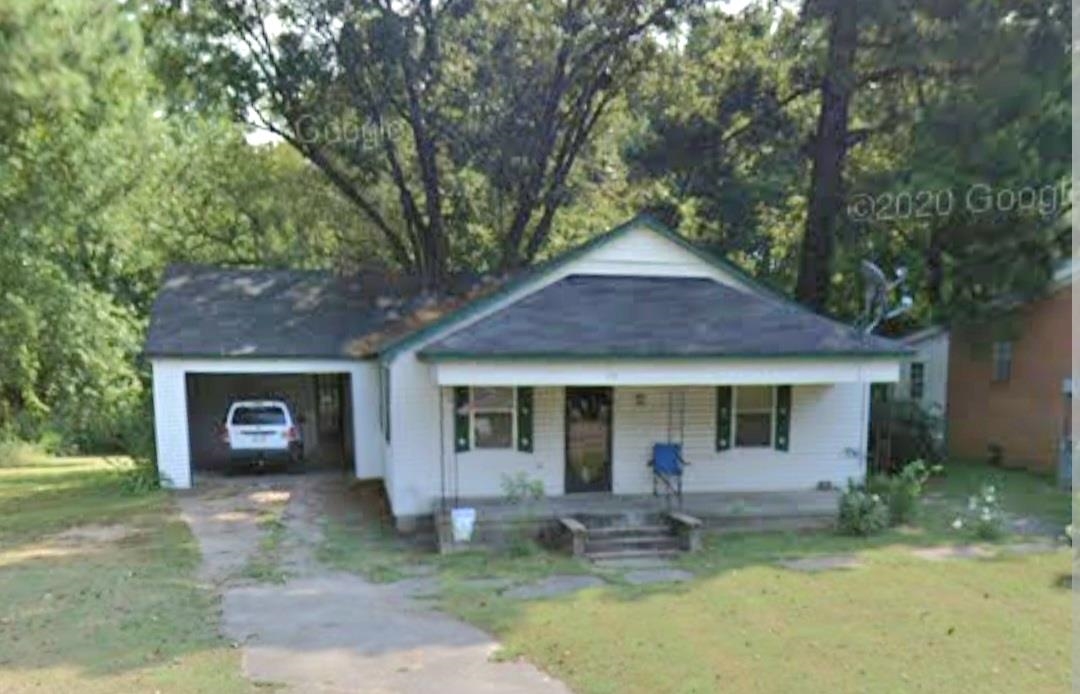 319 North Main Street Ripley, TN 38063 - Photo 1 of 1 a front view of a house with garden and patio