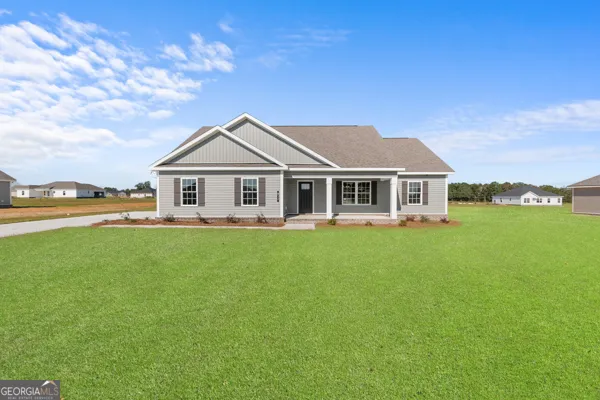 a front view of a house with a garden