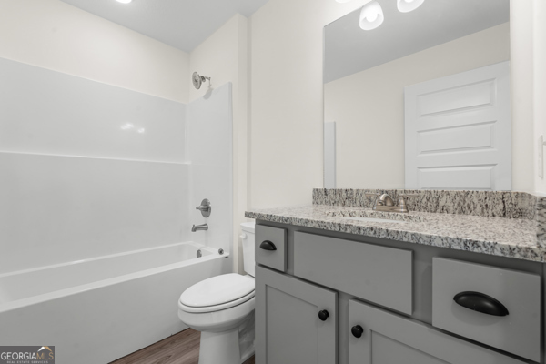 912 Ryegrass Road Statesboro, GA 30458 - Photo 14 of 19 a bathroom with a granite countertop toilet sink and mirror