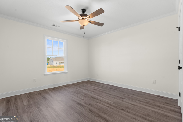 912 Ryegrass Road Statesboro, GA 30458 - Photo 15 of 19 an empty room with wooden floor and windows