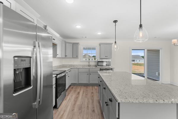 912 Ryegrass Road Statesboro, GA 30458 - Photo 7 of 19 a large kitchen with granite countertop a large counter top appliances and cabinets