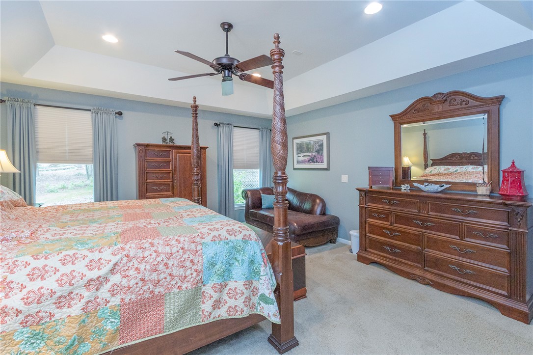 203 Oak Hollow Pendleton, SC 29670 - Photo 21 of 50 Well-lit primary bedroom featuring a tray ceiling, recessed lighting, and soft carpet underfoot.
