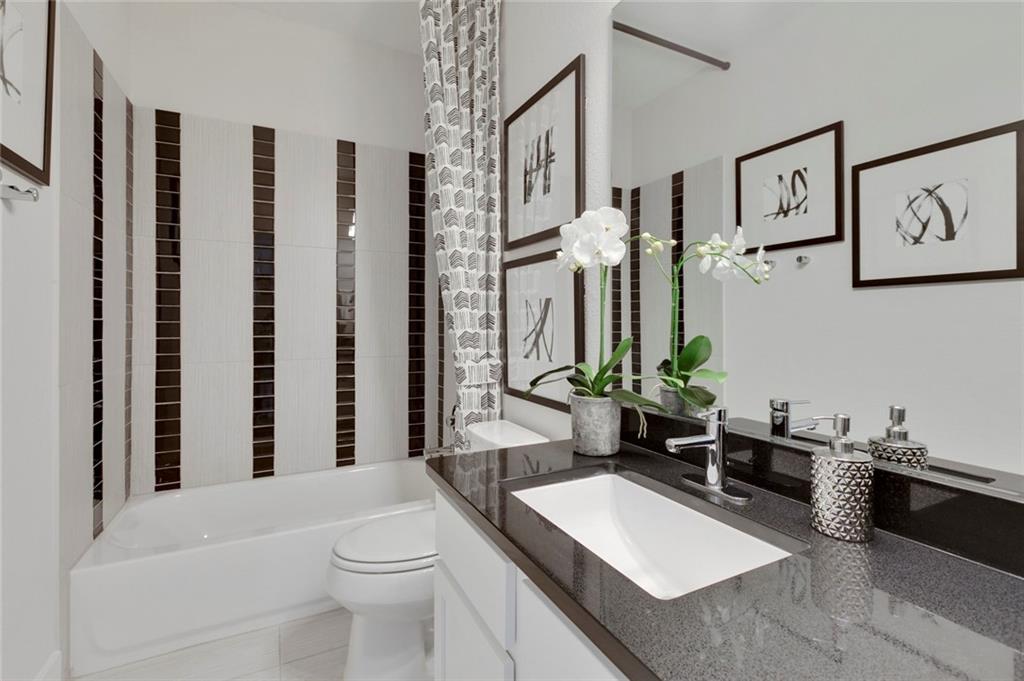 12109 Maypole Bend Austin, TX 78717 - Photo 11 of 27 a bathroom with a toilet a sink and a mirror