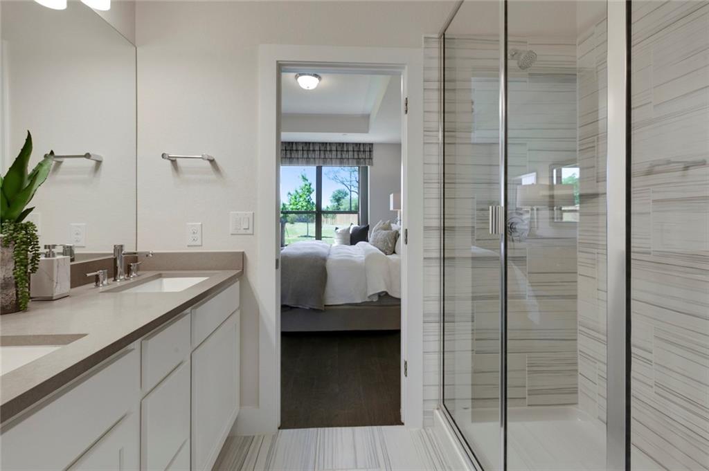 12109 Maypole Bend Austin, TX 78717 - Photo 18 of 27 a en suite bathroom with a granite countertop sink and shower