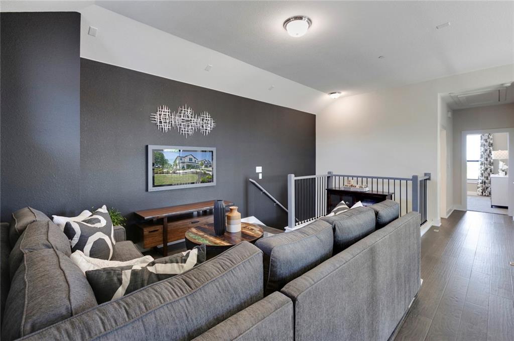 12109 Maypole Bend Austin, TX 78717 - Photo 21 of 27 a living room with furniture and wooden floor