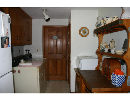 112 Skunknet Road Barnstable, MA 02632 - Photo 8 of 19 a kitchen with a refrigerator and a stove