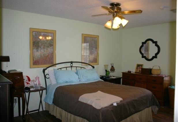 6540 Possum Ridge Road Crestview, FL 32539 - Photo 11 of 23 a bedroom with a bed and dresser with mirror