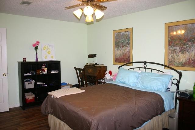 6540 Possum Ridge Road Crestview, FL 32539 - Photo 13 of 23 a bed sitting in a bedroom next to a cabinet
