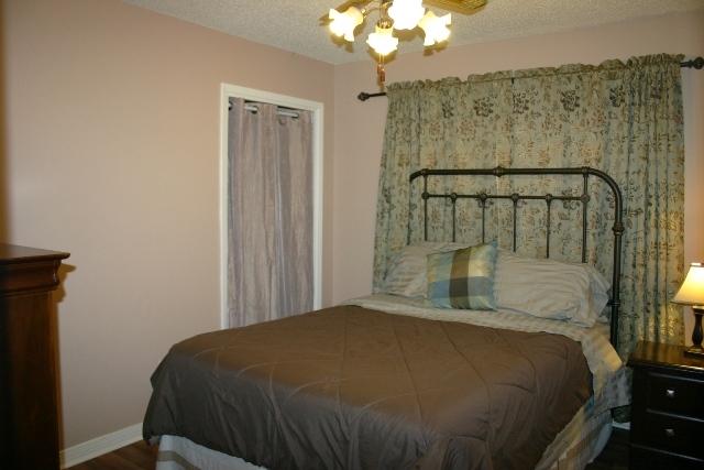 6540 Possum Ridge Road Crestview, FL 32539 - Photo 17 of 23 a bedroom with a bed and a chandelier
