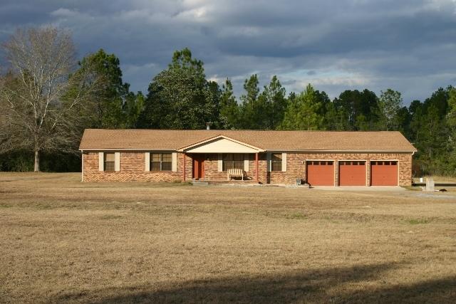 6540 Possum Ridge Road Crestview, FL 32539 - Photo 2 of 23 a front view of a house with a garden