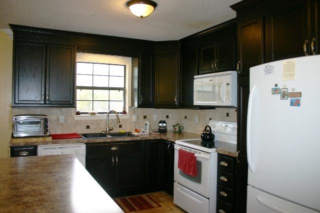 6540 Possum Ridge Road Crestview, FL 32539 - Photo 5 of 23 a kitchen with a sink and a stove top oven