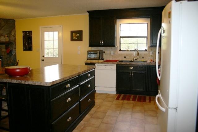 6540 Possum Ridge Road Crestview, FL 32539 - Photo 6 of 23 a kitchen with a sink window and cabinets